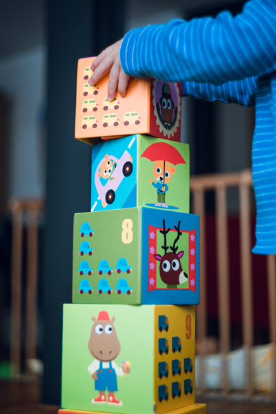 toddler playing building blocks