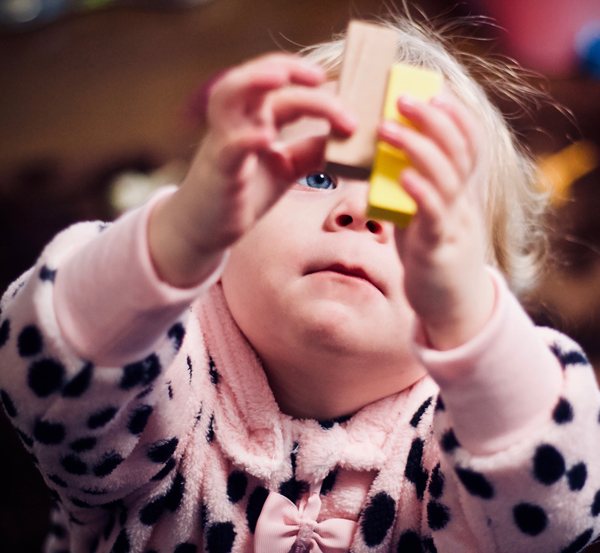 child playing with wooden blocks