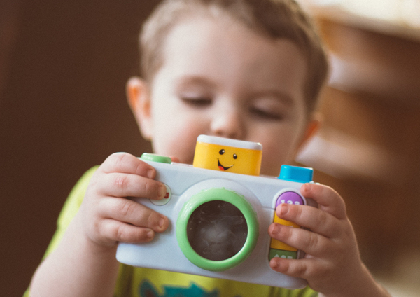 toddler with toy camera